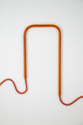 Front view of Amber Earth glass self-watering insert on a clean white background showing its warm amber and terracotta tones.