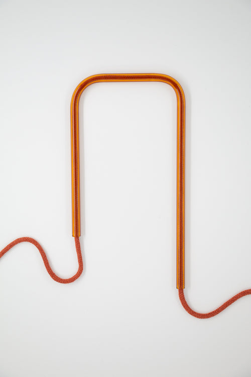 Front view of Amber Earth glass self-watering insert on a clean white background showing its warm amber and terracotta tones.