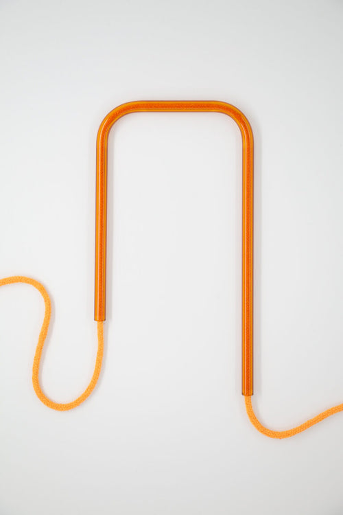 Front view of Amber Flame glass self-watering insert on a clean white background showing its rich orange and fiery amber design details.