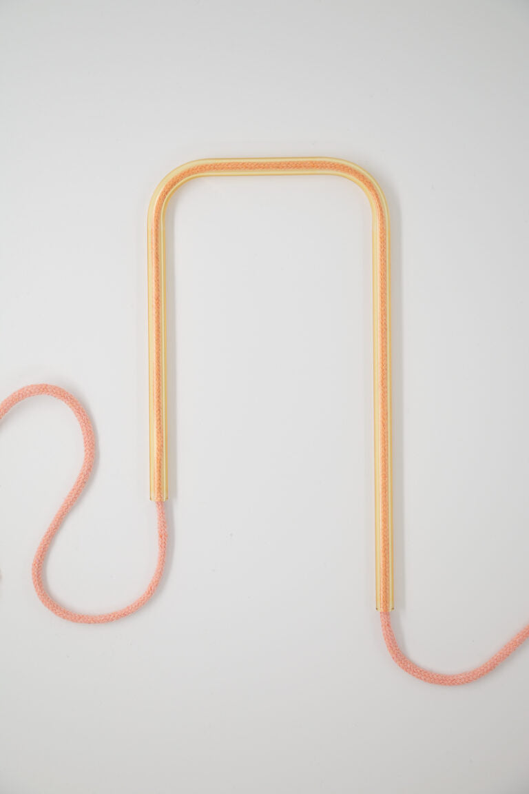 Front view of Honey Blush glass self-watering insert on a clean white background showing its beautiful blend of warm yellow and soft pink tones.