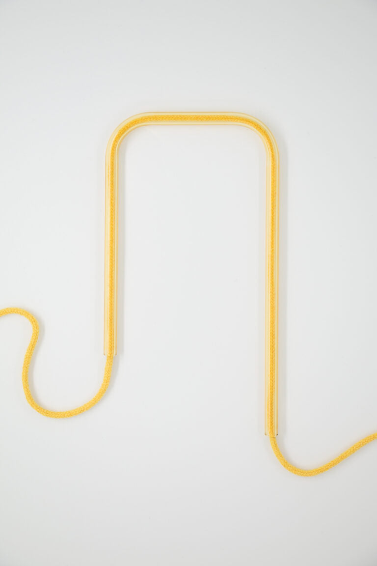 Front view of Sweet Sunshine glass self-watering insert on a clean white background showing its bright yellow and white design details.